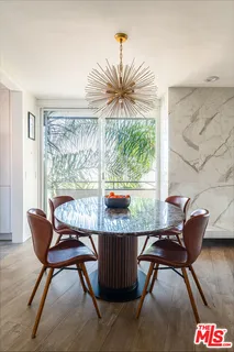 a close view of a sink a toilet and a potted plant