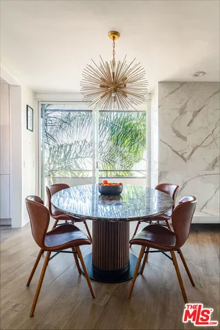 a close view of a sink a toilet and a potted plant