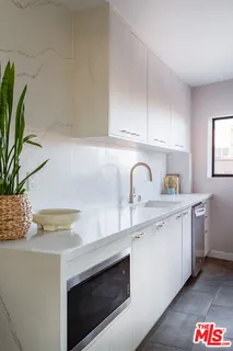 a kitchen with stainless steel appliances granite countertop a refrigerator and a stove