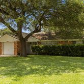 a view of a big yard with large trees