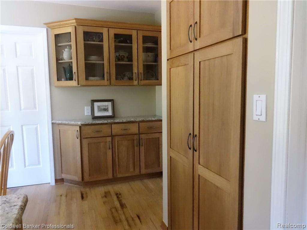 5065 Aintree Court Rochester, MI 48306 - Photo 16 of 59 5065 Aintree Ct_Laundry room to left, hickory cabinets/pantry