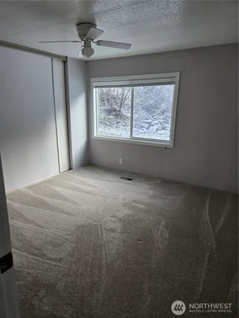 a view of a room with rack on the wall and a shower
