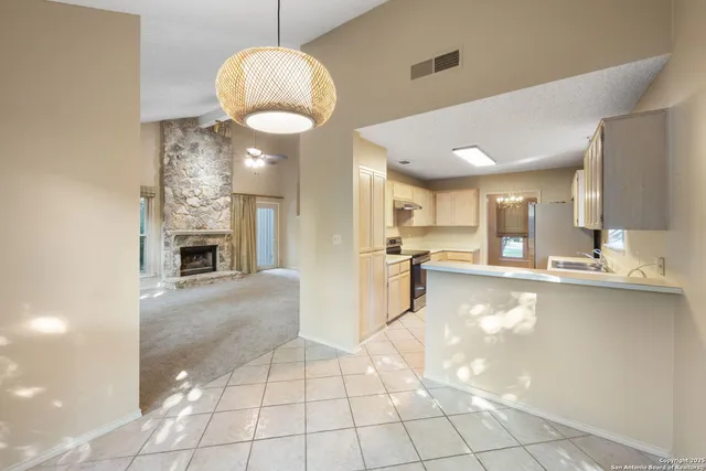 a view of kitchen and dining area with chandelier