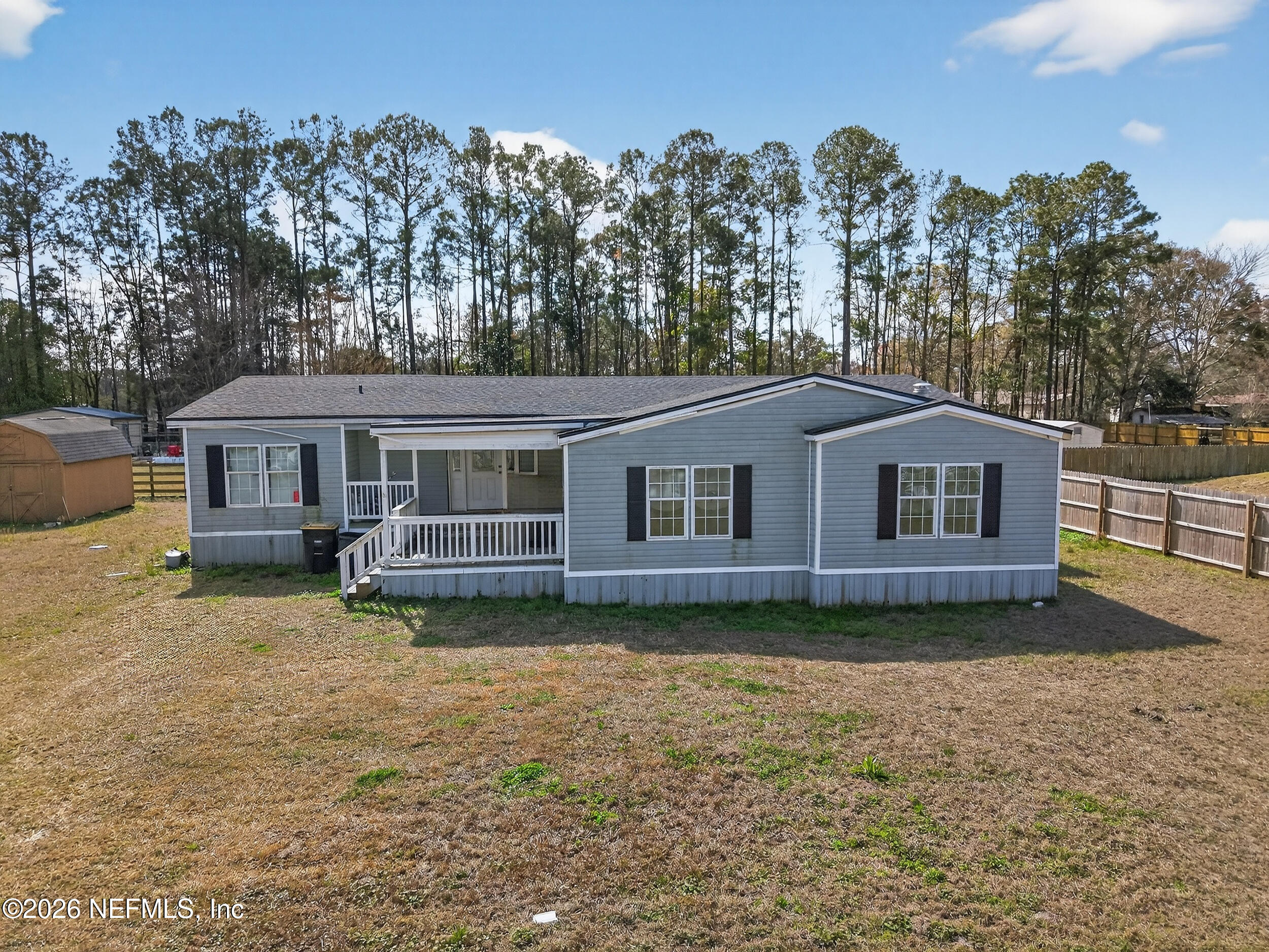 634 Harrison Street Jacksonville, FL 32220 - Photo 1 of 23 a front view of a house with a garden and trees