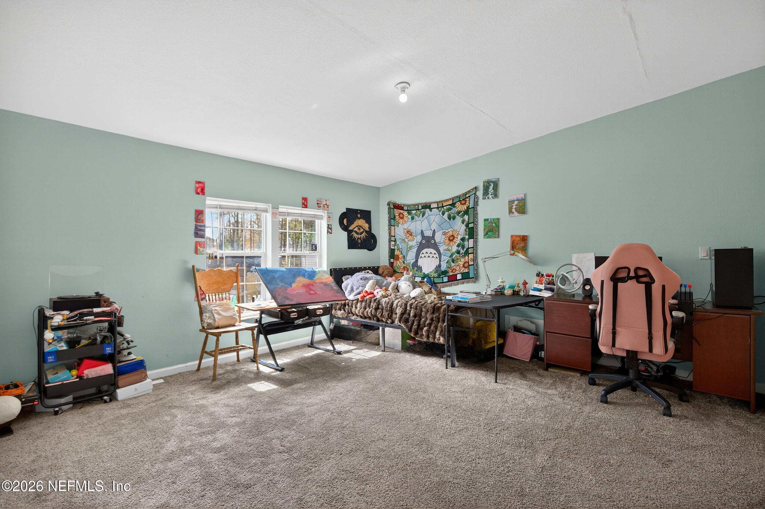 634 Harrison Street Jacksonville, FL 32220 - Photo 11 of 23 a living room with lots of furniture and a gym machine