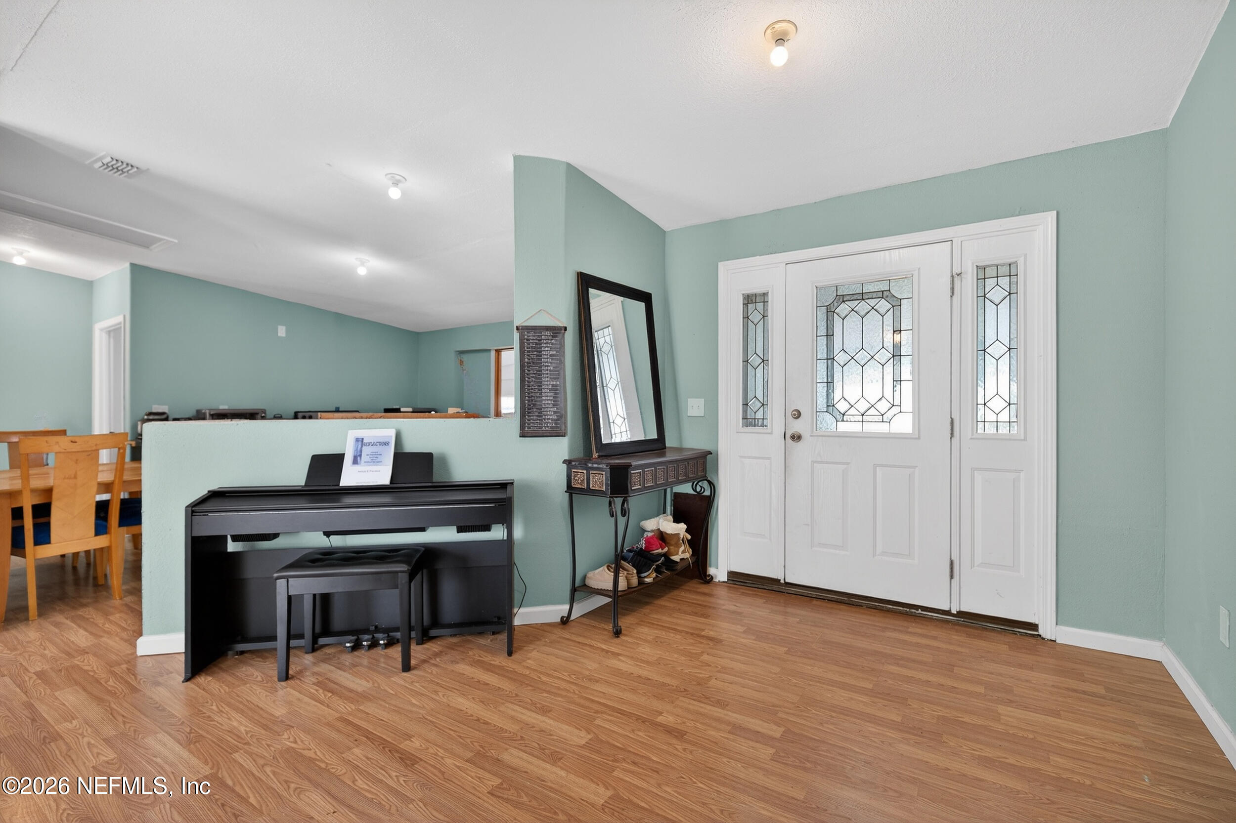 634 Harrison Street Jacksonville, FL 32220 - Photo 4 of 23 a view of a workspace with furniture and wooden floor
