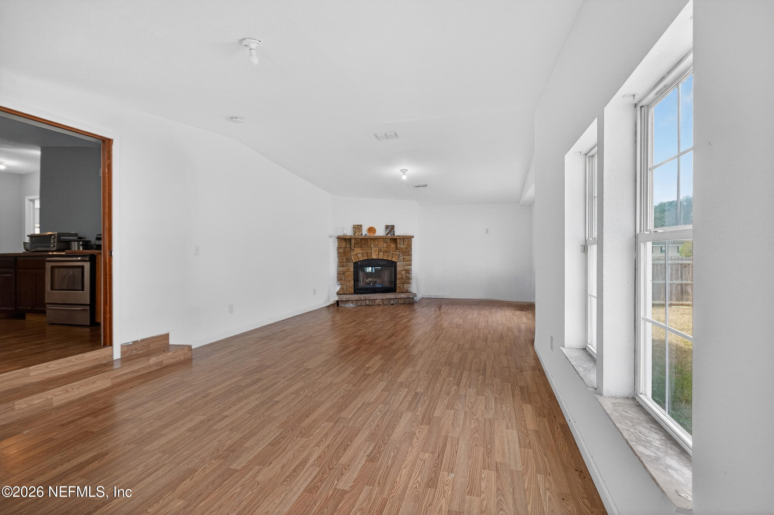 634 Harrison Street Jacksonville, FL 32220 - Photo 7 of 23 wooden floor in an empty room with a window