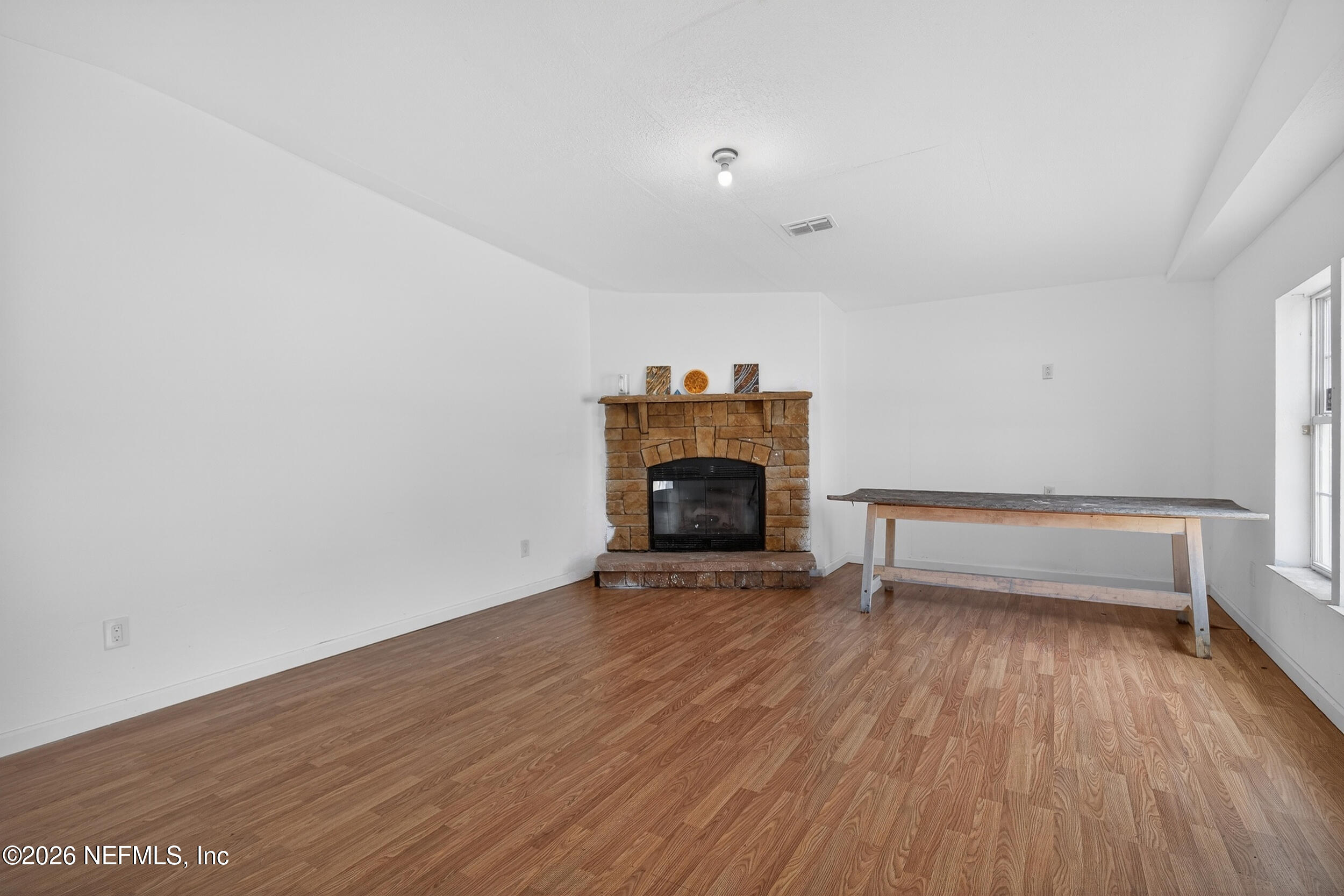 634 Harrison Street Jacksonville, FL 32220 - Photo 8 of 23 a view of empty room with wooden floor and fireplace