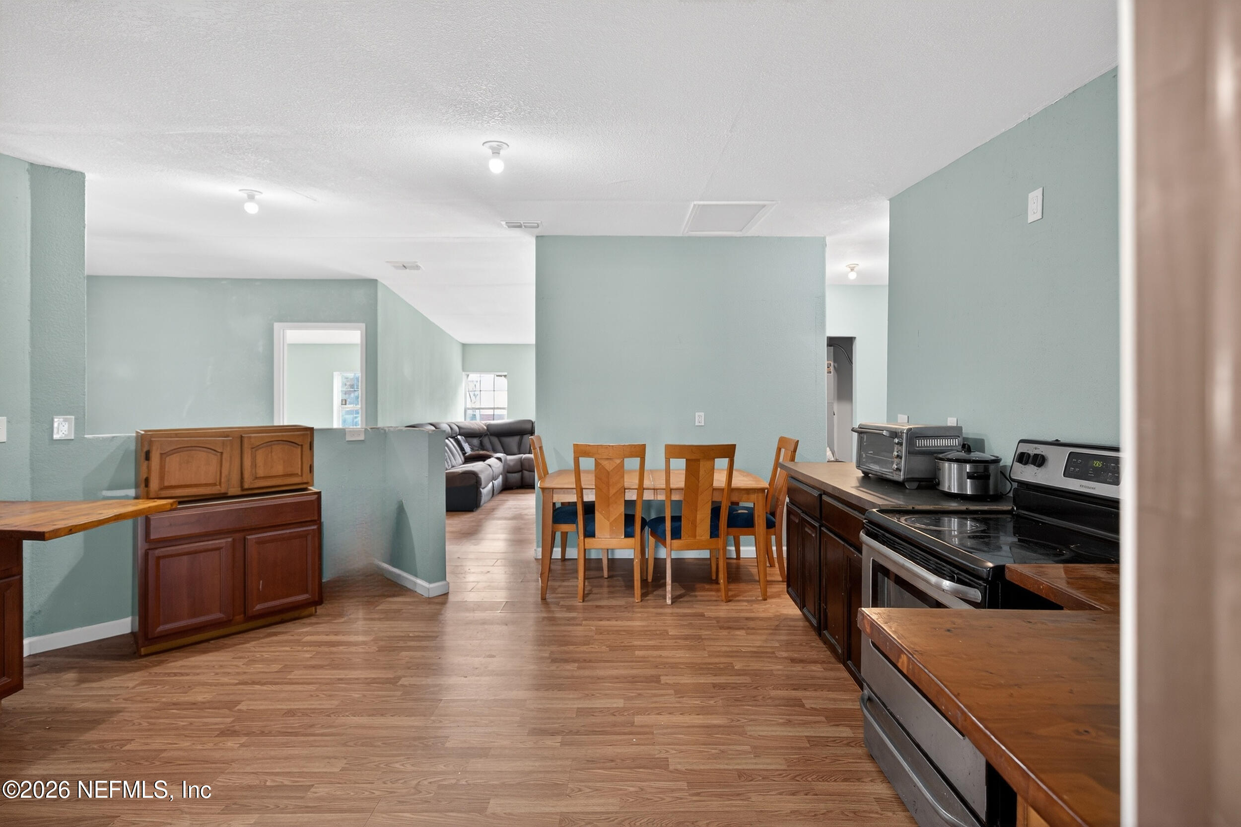 634 Harrison Street Jacksonville, FL 32220 - Photo 10 of 23 a large kitchen with lots of counter and chairs