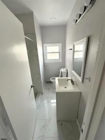 a bathroom with a sink toilet and mirror