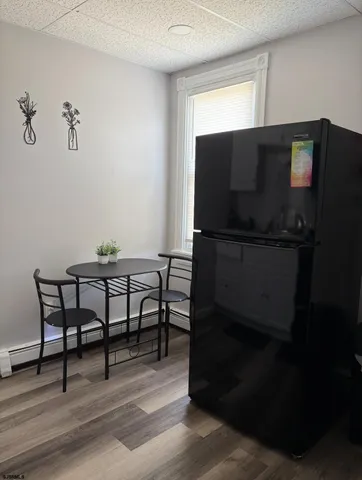 a workspace room with furniture and wooden floor