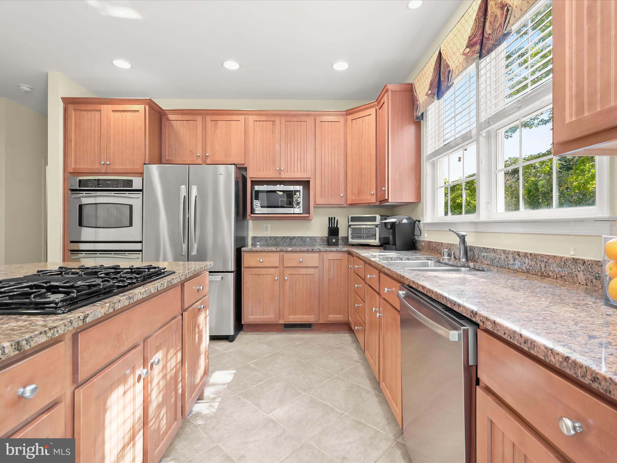 1525 Winfields Lane Gambrills, MD 21054 - Photo 22 of 65 a kitchen with stainless steel appliances granite countertop a stove a sink dishwasher a refrigerator and a microwave