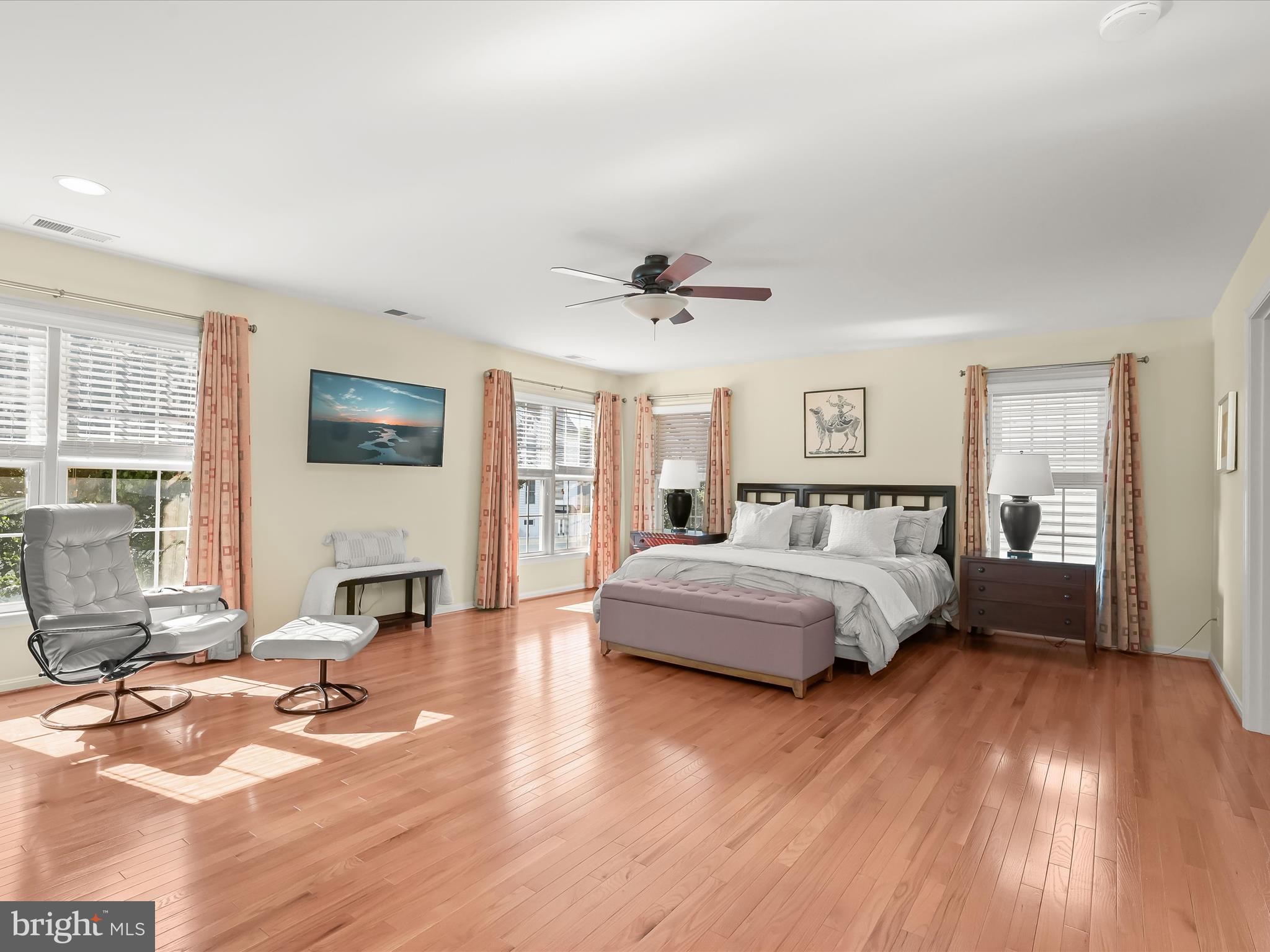 1525 Winfields Lane Gambrills, MD 21054 - Photo 31 of 65 a spacious bedroom with a large bed a chandelier and windows