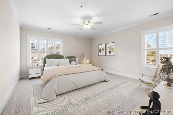 a bedroom with a large bed and a chandelier