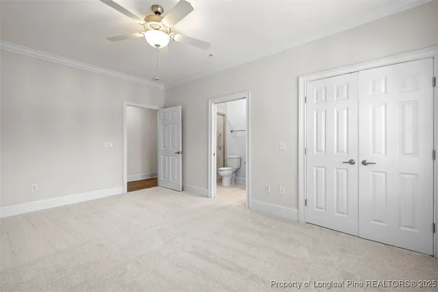 a view of an empty room with a ceiling fan