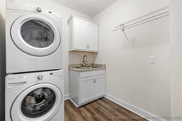 a utility room with sink dryer and washer