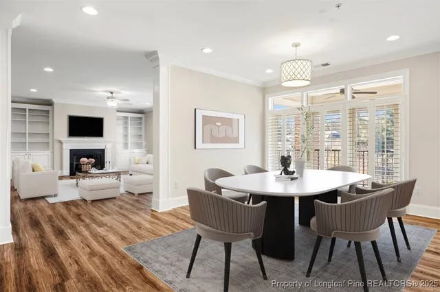 a view of a dining room with furniture a chandelier and wooden floor