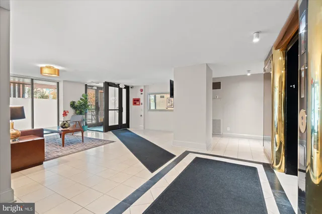 a living room with furniture and large window