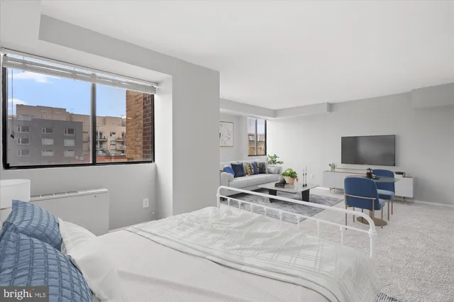 a bedroom with a large bed and a flat screen tv