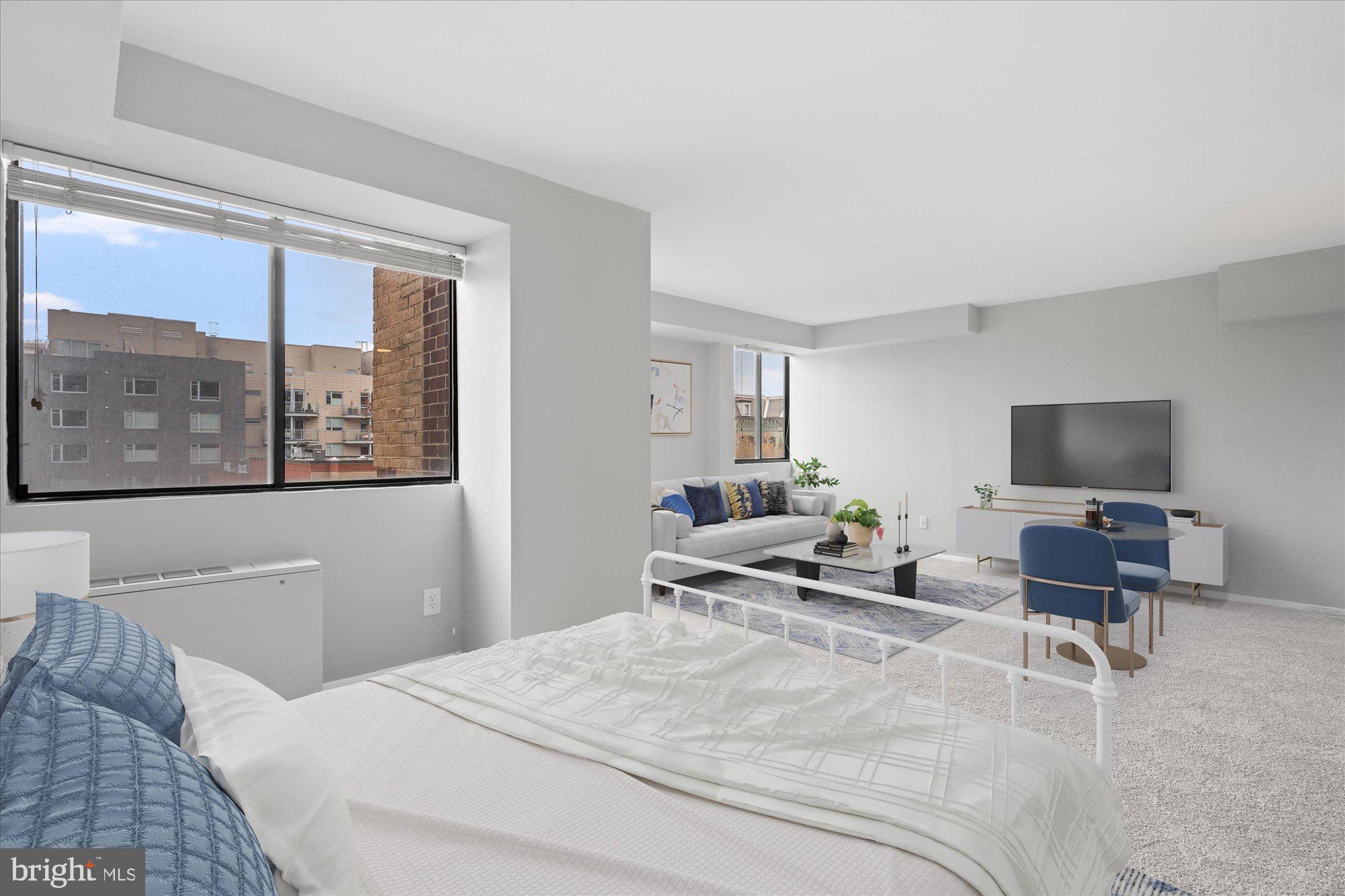 1245 13th Street Northwest, Unit 508 Washington, DC 20005 - Photo 4 of 15 a bedroom with a large bed and a flat screen tv