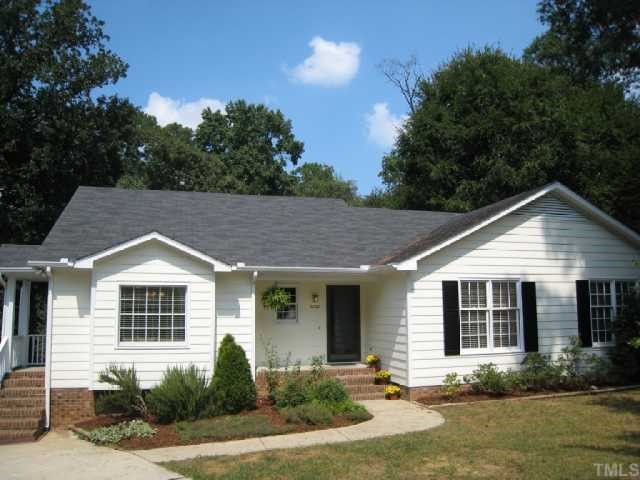 5208 Badham Place Raleigh, NC 27609 - Photo 1 of 12 a front view of a house with yard and green space