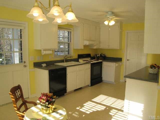 5208 Badham Place Raleigh, NC 27609 - Photo 4 of 12 a kitchen with a sink appliances and cabinets