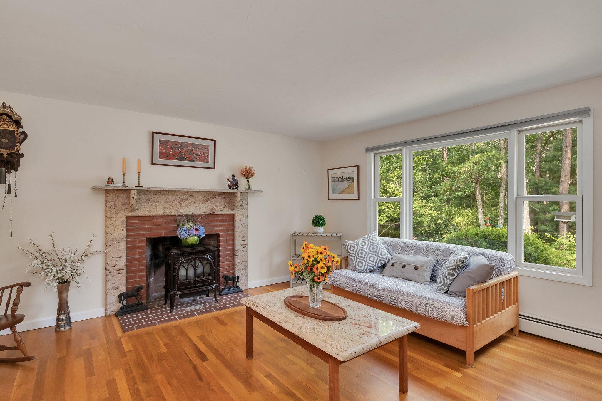 565 Sampsons Mill Road Cotuit, MA 02635 - Photo 12 of 87 a living room with furniture and a fireplace