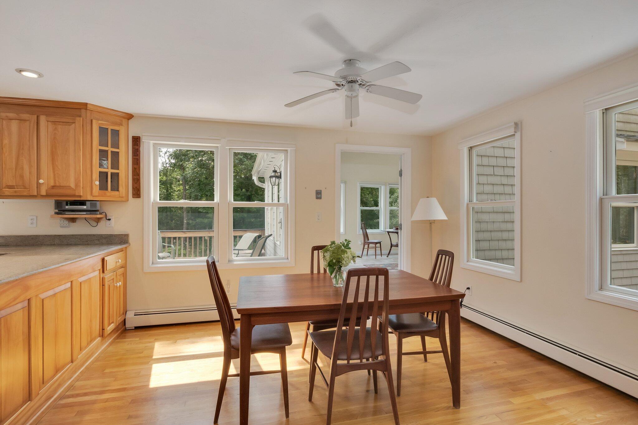 565 Sampsons Mill Road Cotuit, MA 02635 - Photo 15 of 87 a view of a dining room with furniture window and wooden floor