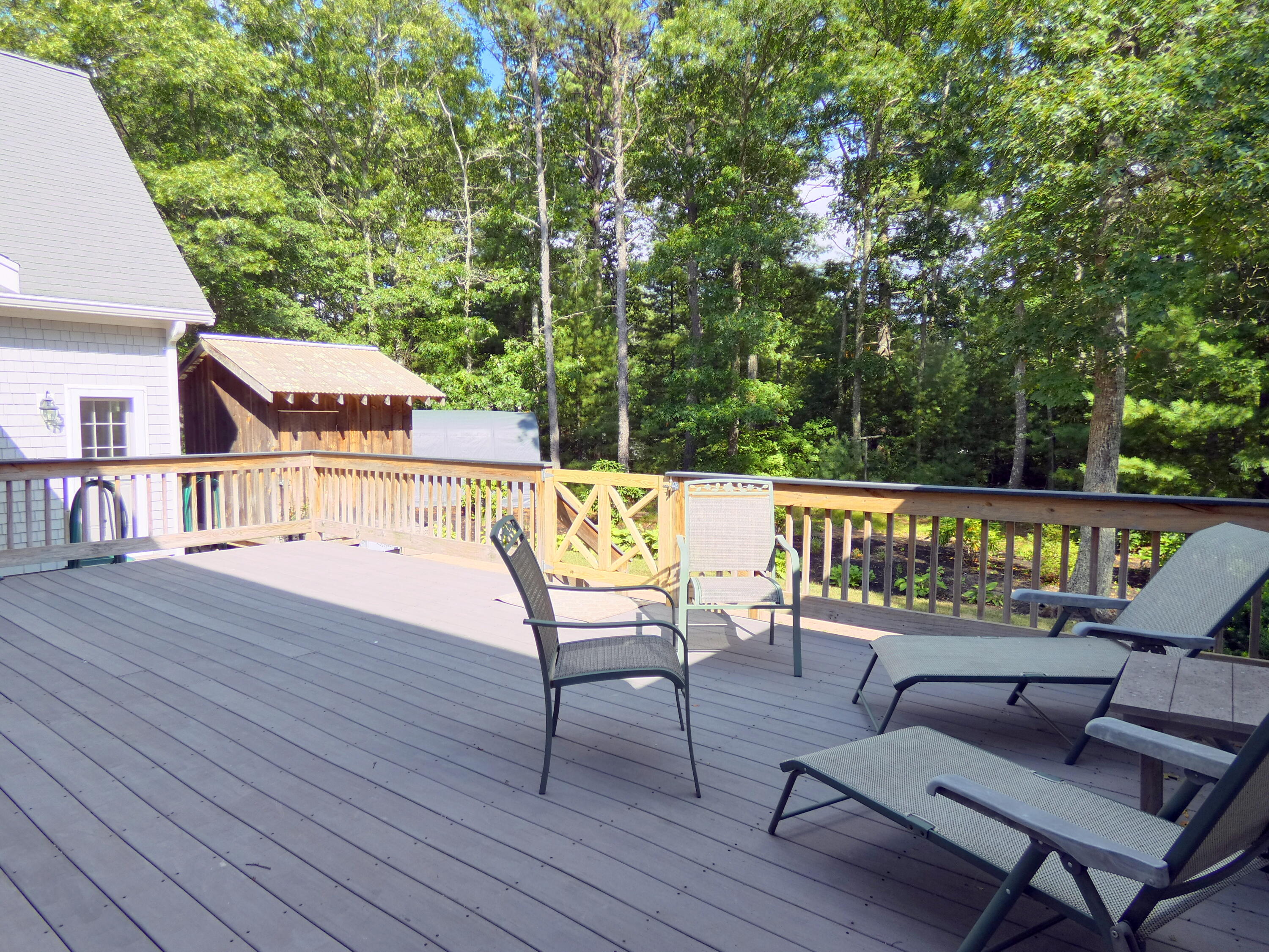 565 Sampsons Mill Road Cotuit, MA 02635 - Photo 29 of 87 an outdoor sitting area with furniture and wooden floor
