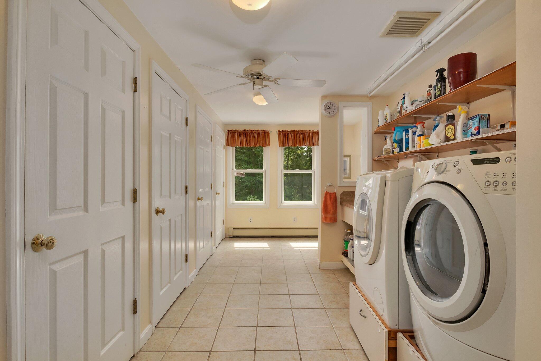 565 Sampsons Mill Road Cotuit, MA 02635 - Photo 36 of 87 a view of a hallway with washer and dryer