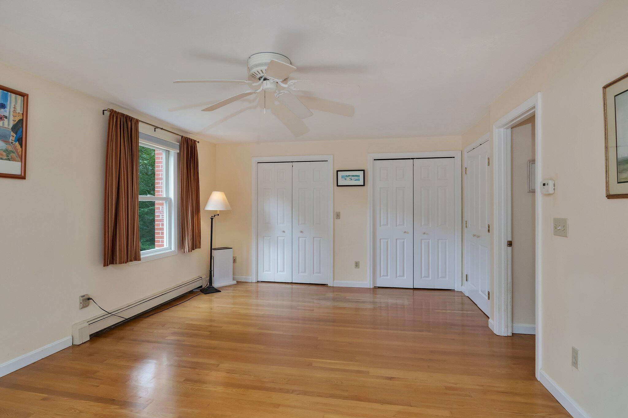 565 Sampsons Mill Road Cotuit, MA 02635 - Photo 40 of 87 a view of an empty room with wooden floor and a window