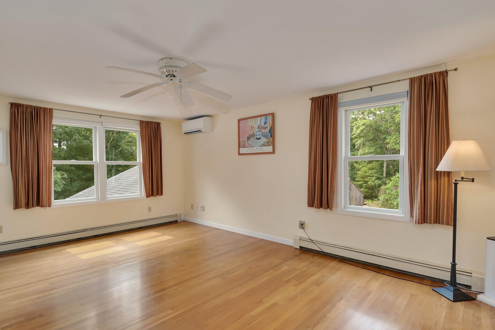 565 Sampsons Mill Road Cotuit, MA 02635 - Photo 42 of 87 a view of an empty room with wooden floor and a window