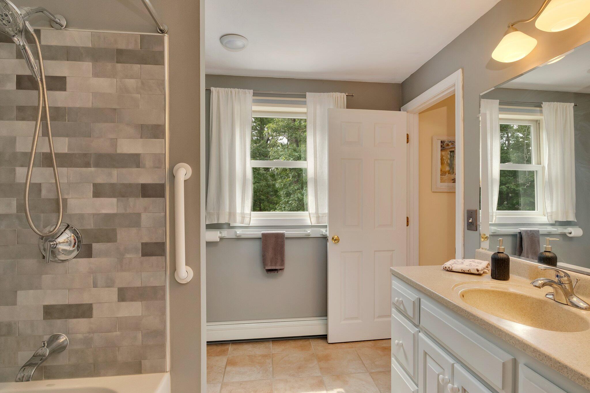 565 Sampsons Mill Road Cotuit, MA 02635 - Photo 45 of 87 a bathroom with a granite countertop sink a mirror and a shower