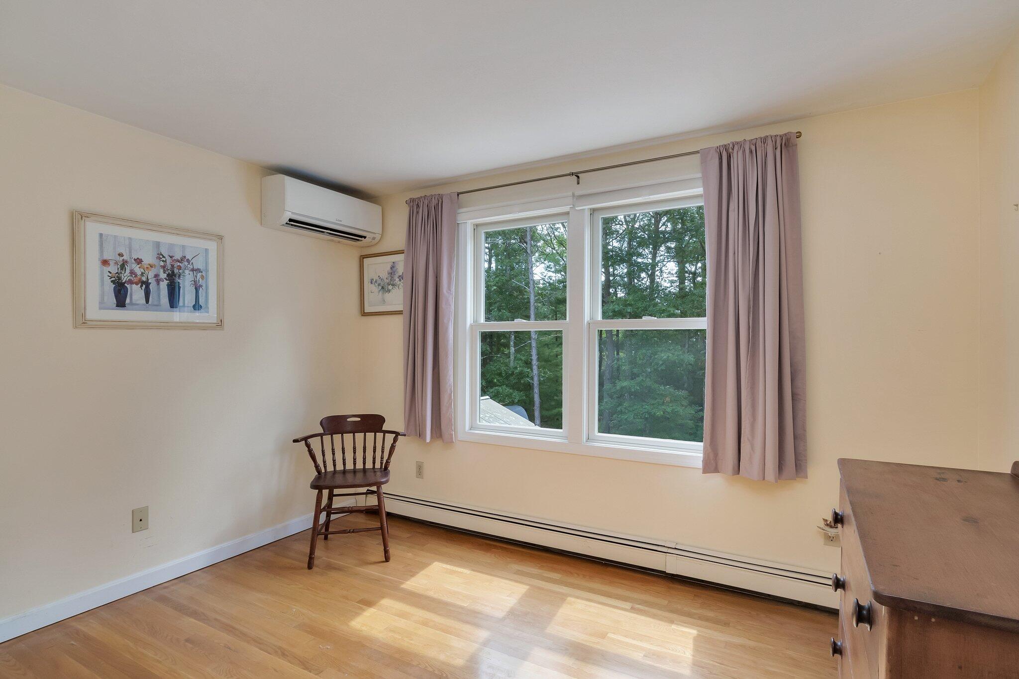 565 Sampsons Mill Road Cotuit, MA 02635 - Photo 52 of 87 a living room with a window and a chair