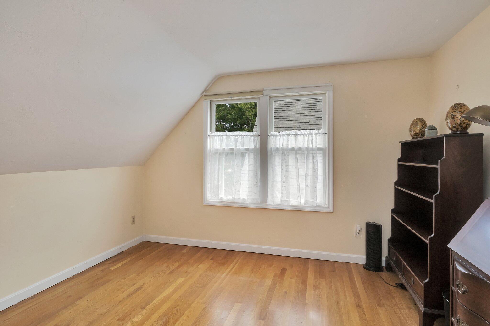 565 Sampsons Mill Road Cotuit, MA 02635 - Photo 56 of 87 an empty room with wooden floor and windows