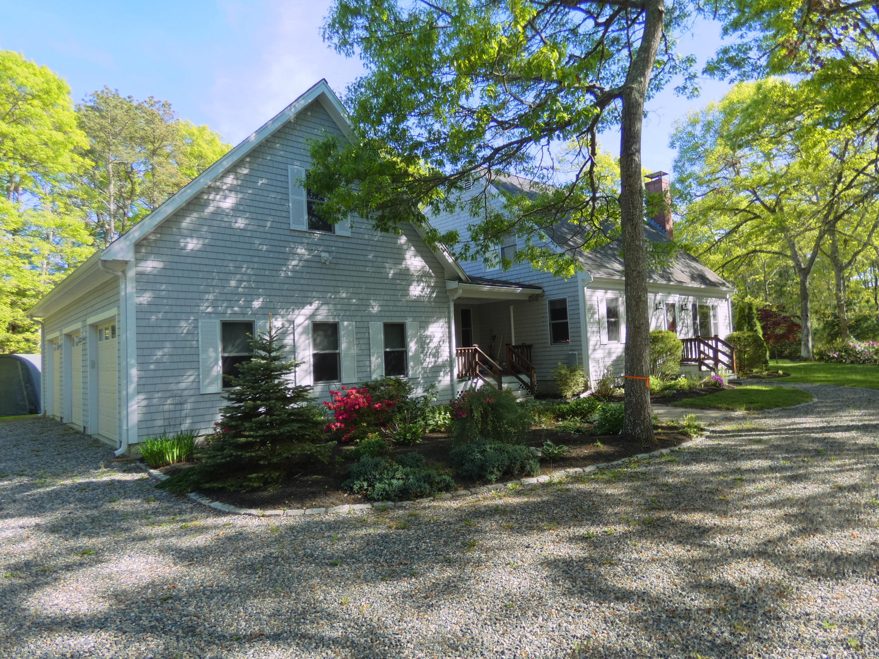 565 Sampsons Mill Road Cotuit, MA 02635 - Photo 60 of 87 a front view of a house with garden