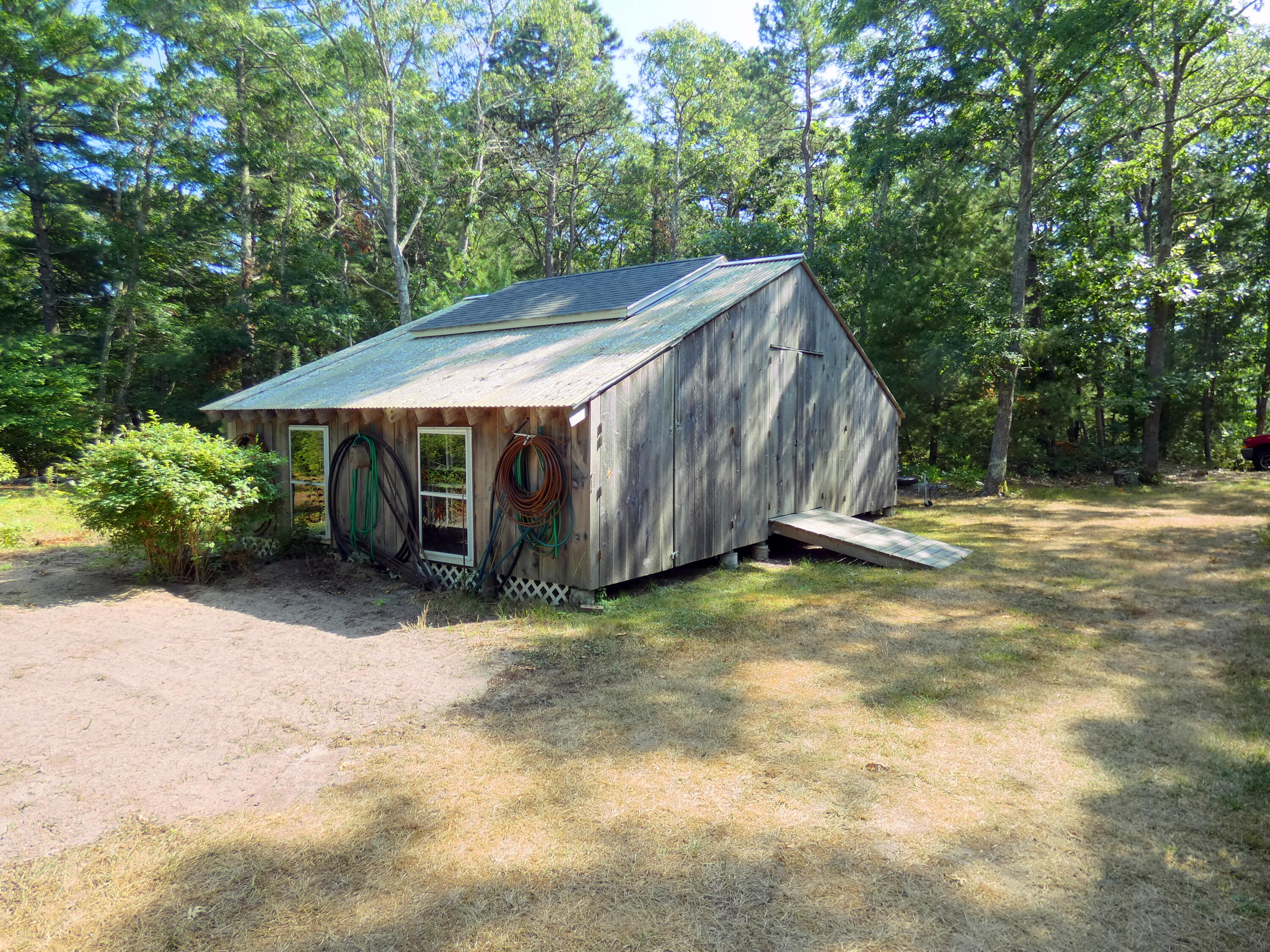 565 Sampsons Mill Road Cotuit, MA 02635 - Photo 61 of 87 a backyard of a house with yard and trampoline