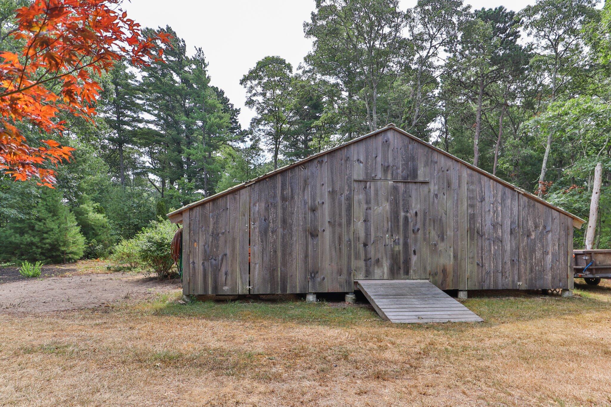 565 Sampsons Mill Road Cotuit, MA 02635 - Photo 62 of 87 a backyard of house with wooden fence