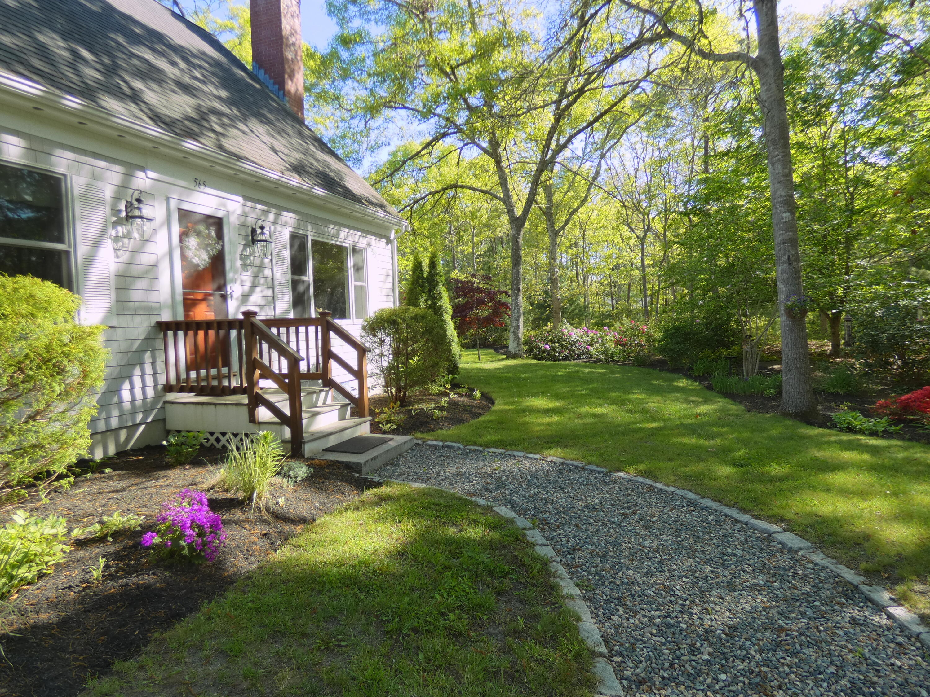 565 Sampsons Mill Road Cotuit, MA 02635 - Photo 8 of 87 a view of a house with backyard and garden