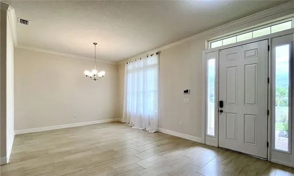 an empty room with wooden floor and mirror