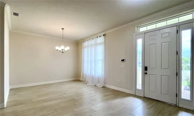 an empty room with wooden floor and mirror