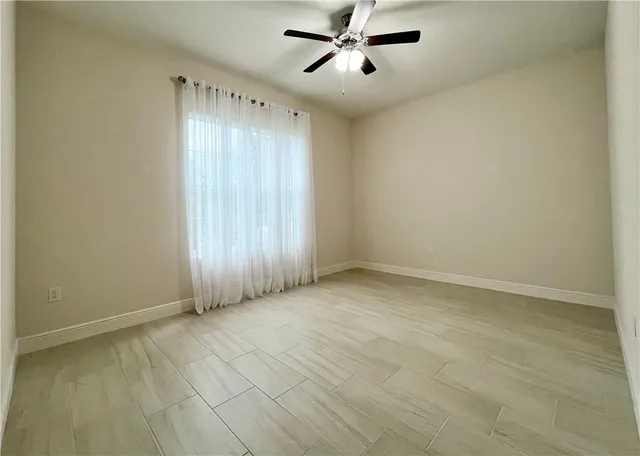 an empty room with a empty space and windows