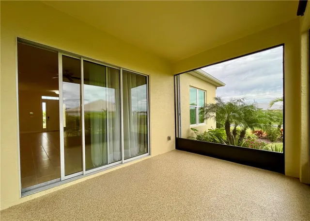 a view of a porch with a table and chairs