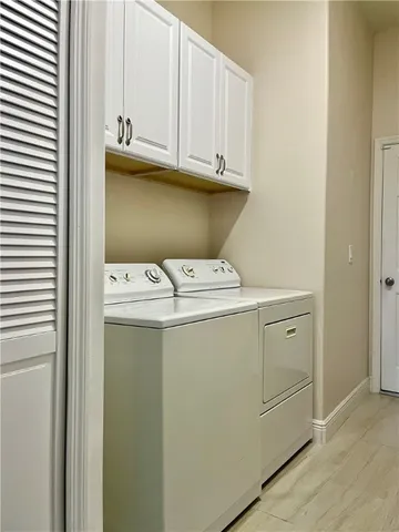 an aerial view of a house with outdoor space and trees all around