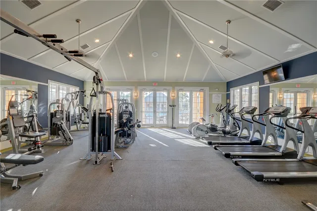 a room with pool table and windows