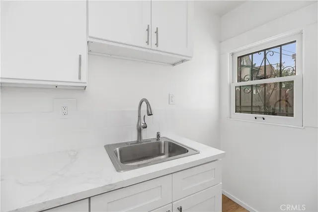 a kitchen with a sink stove and cabinets