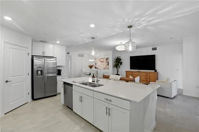 a kitchen with refrigerator and cabinets