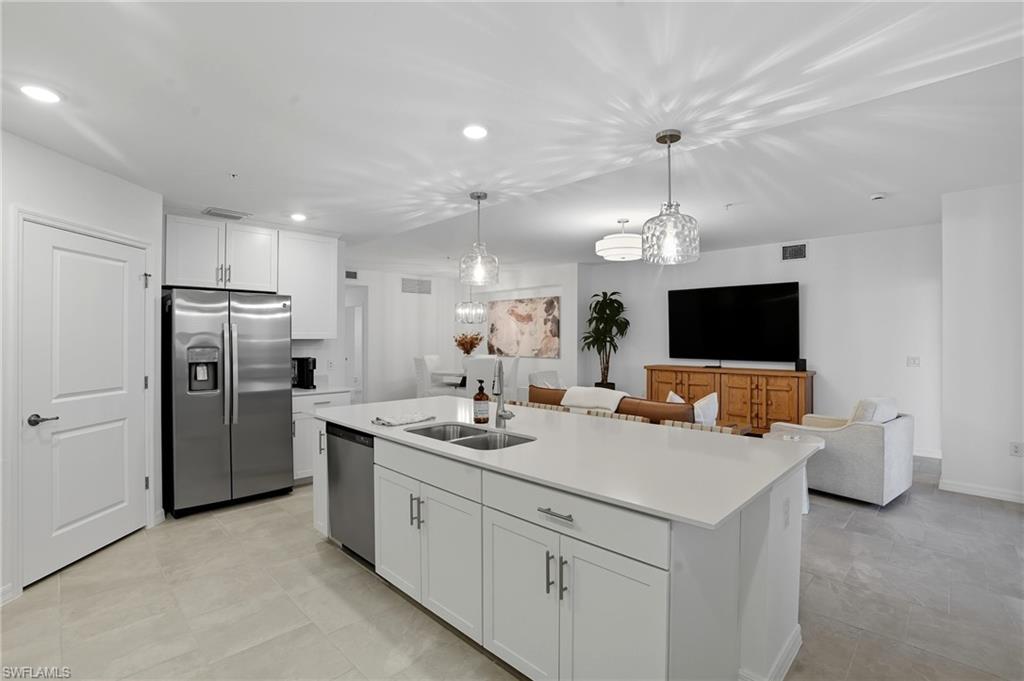 5667 Melbourne Court, Unit 7812 Ave Maria, FL 34142 - Photo 11 of 49 a kitchen with refrigerator and cabinets