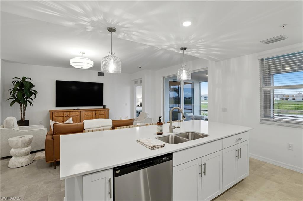 5667 Melbourne Court, Unit 7812 Ave Maria, FL 34142 - Photo 12 of 49 a living room with furniture and a flat screen tv