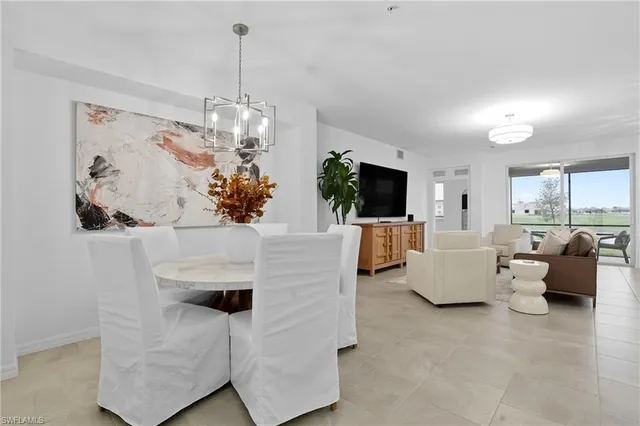 a living room with fireplace furniture and a chandelier